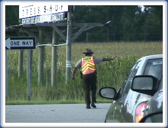 The cops stop the traffic to let everyone out of the church parking lot