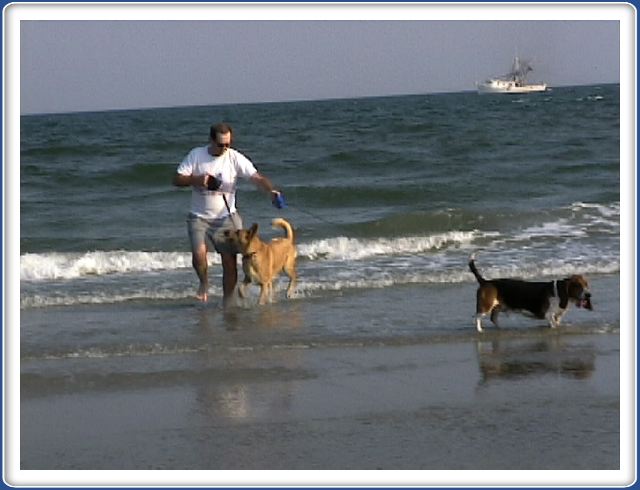 Playing in the ocean - a shrimp boat in the background