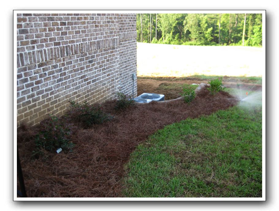 Right of the steps and retaining wall