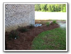 Right of the steps and retaining wall